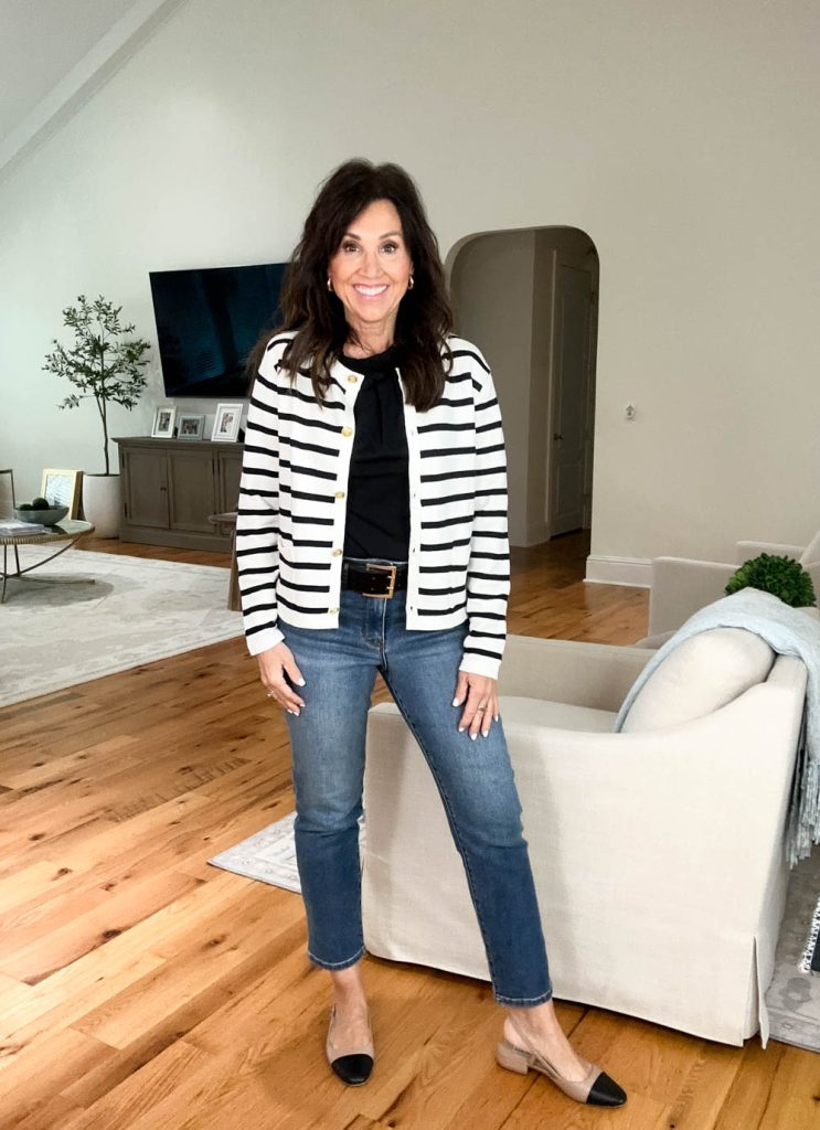 Cyndi wearing a black and white striped cardigan over a black top with jeans and two-tone flats, an easy fall Amazon outfit idea.