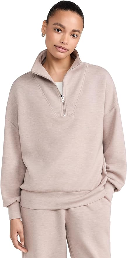 Varley Hawley half zip sweater in a light pink styled on an adult woman