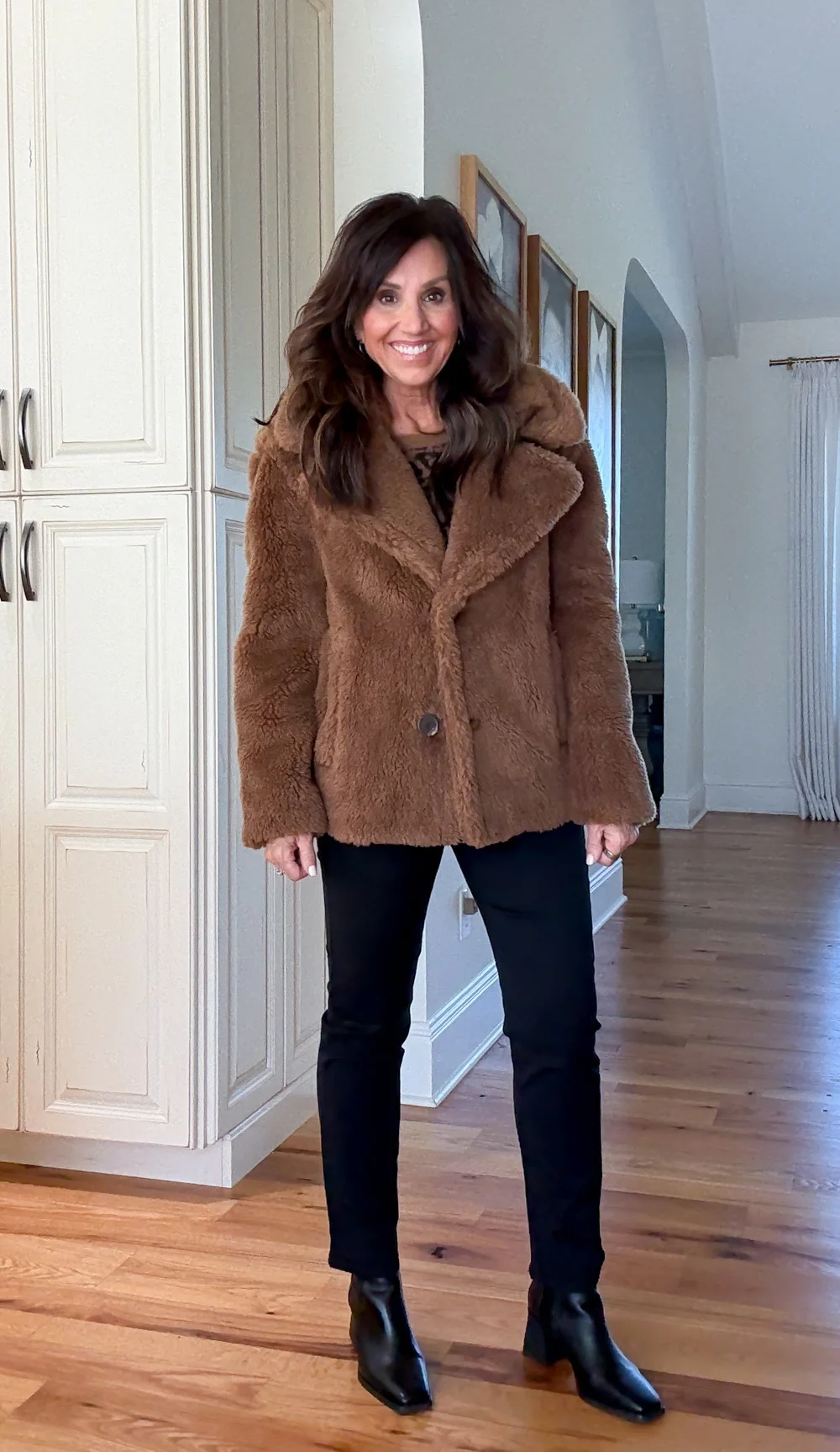 Cyndi Spivey wearing a cozy brown teddy coat with jeans and boots, perfect for cold winter days