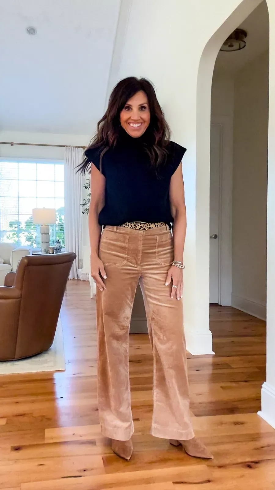 Cyndi Spivey wearing flare corduroy pants with boots and a sweater.