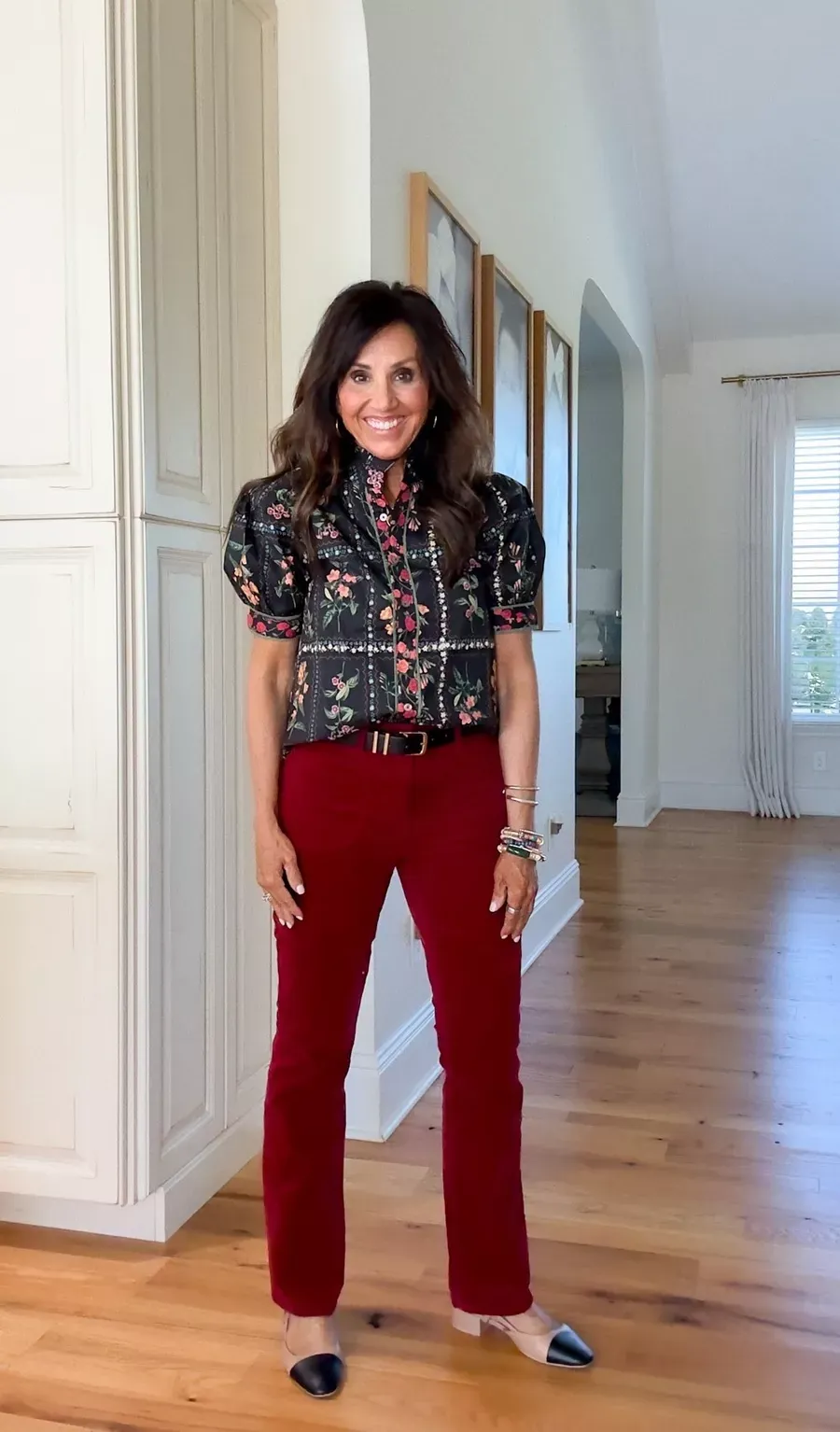 Cyndi Spivey styling a corduroy outfit with burgundy pants and a floral blouse for fall.