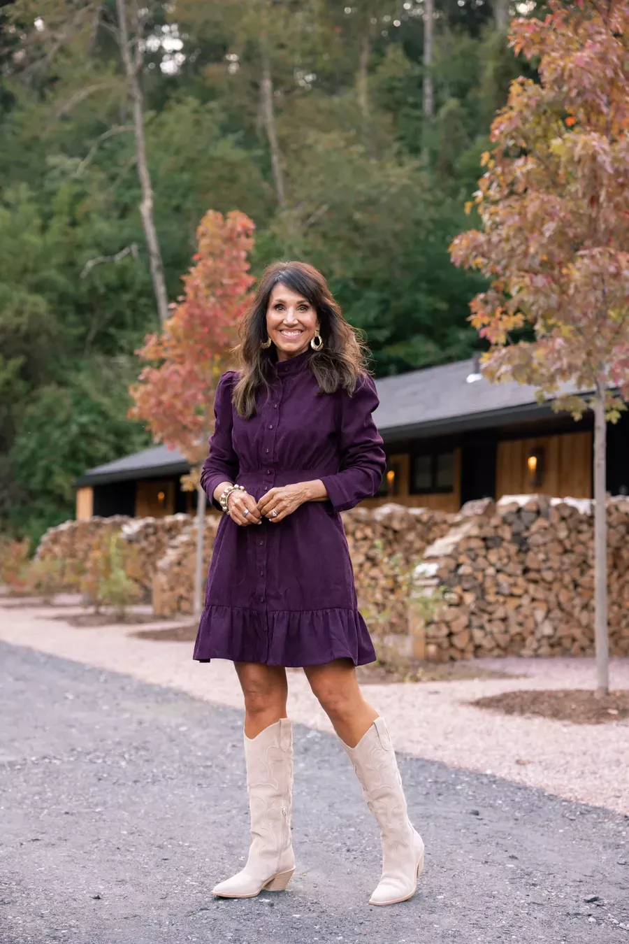 Woman styling corduroy dress outfit with tall boots