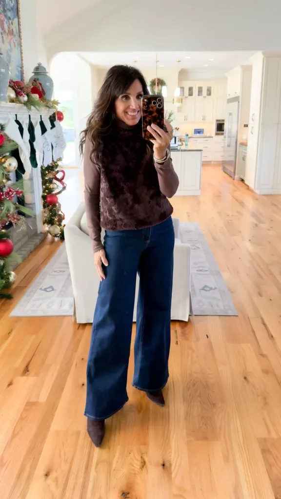 Cyndi Spivey wearing dark wash wide-leg jeans styled with a casual top and boots.
