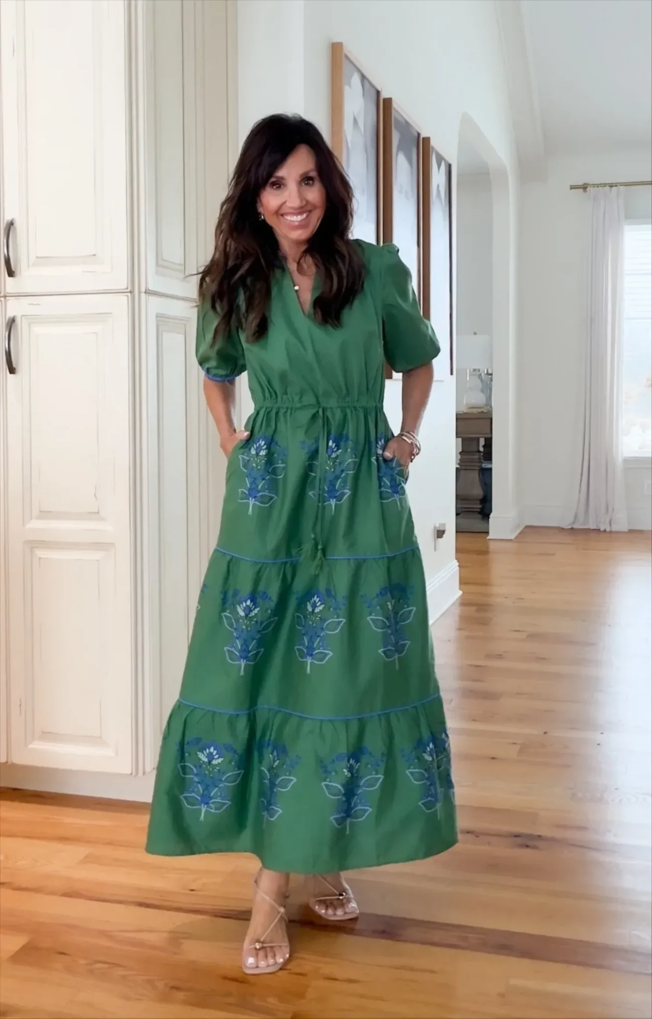 Cyndi wearing a blue and green dress.
