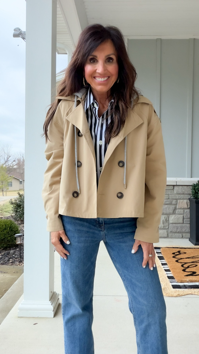Cyndi wearing a cropped trench jacket in spring 2026.