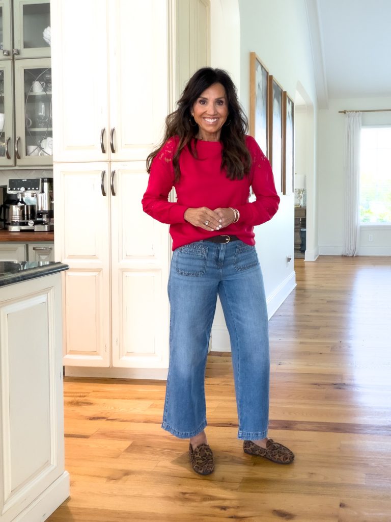 Cropped patch-pocket jeans styled with a red sweater and leopard print shoes