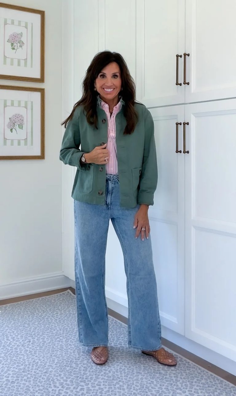 Light wash full-length wide-leg jeans styled with a green jacket and pink striped shirt