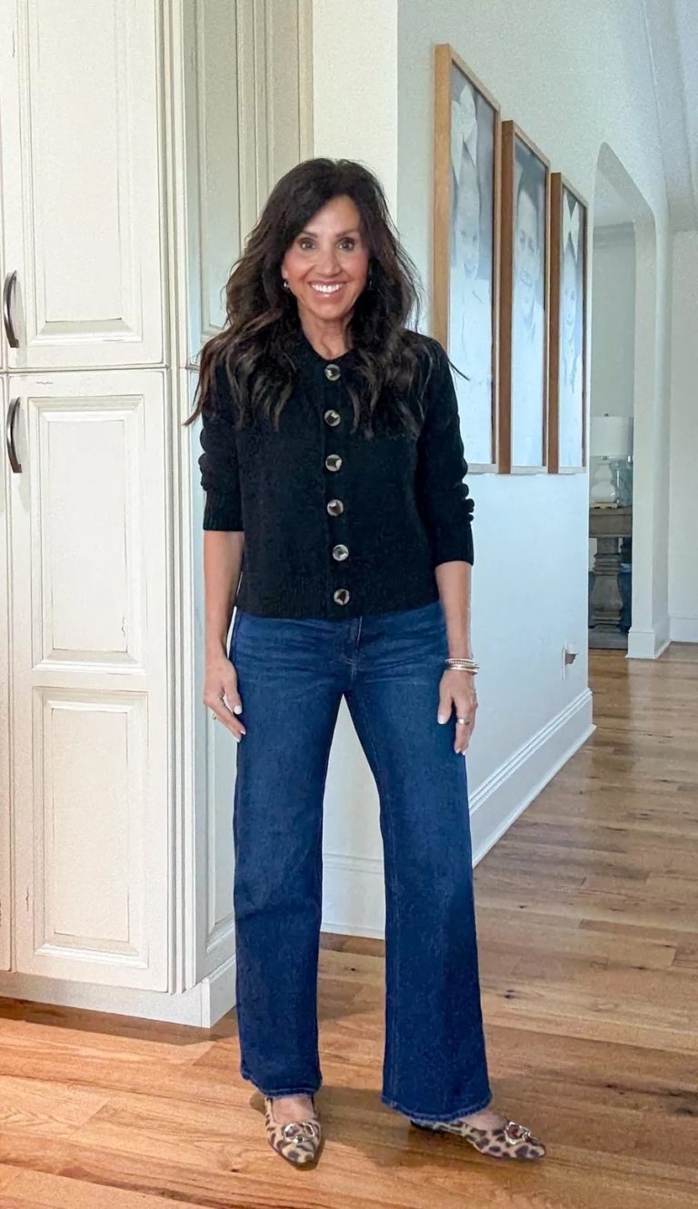Dark wash straight-leg jeans styled with a black cardigan and leopard print flats