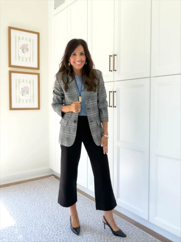 Cyndi wearing an outfit with a long necklace for fall 2026